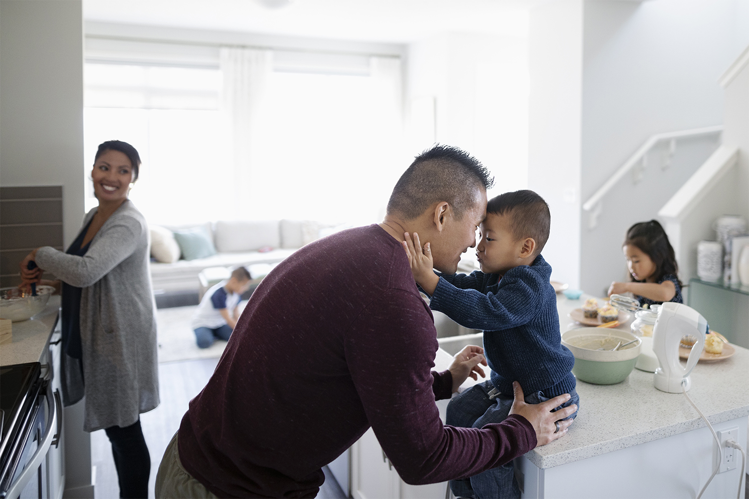 Affectionate family making breakfast in kitchen